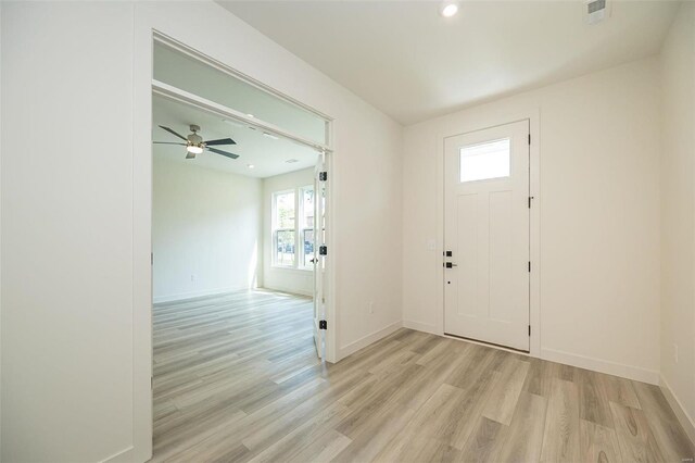 entrance foyer with ceiling fan and light wood-type flooring