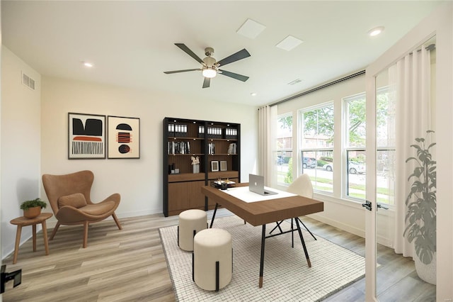 office space featuring light wood-type flooring and ceiling fan