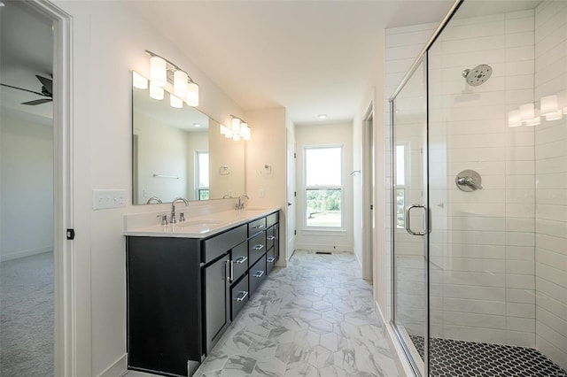 bathroom featuring ceiling fan, an enclosed shower, and vanity