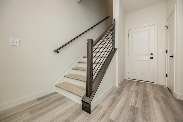 stairs with hardwood / wood-style floors