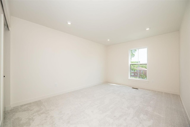 spare room with light colored carpet