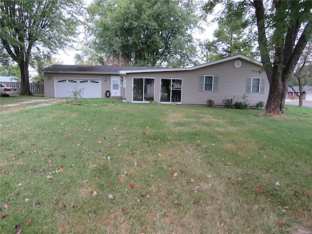 single story home featuring a front lawn and a garage