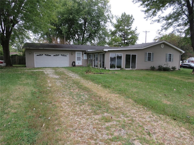 ranch-style house featuring a garage and a front lawn