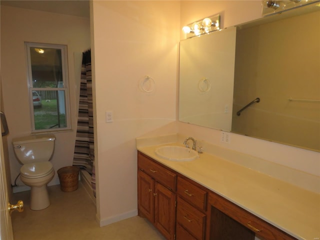 bathroom featuring a shower with shower curtain, toilet, and vanity