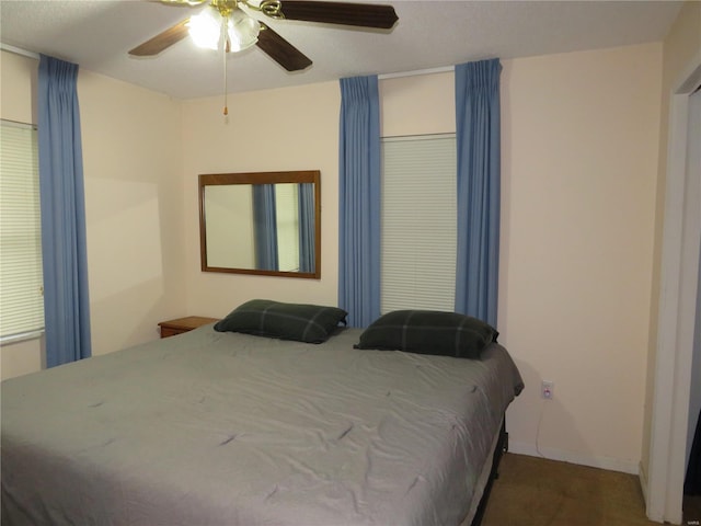 bedroom with ceiling fan and carpet flooring