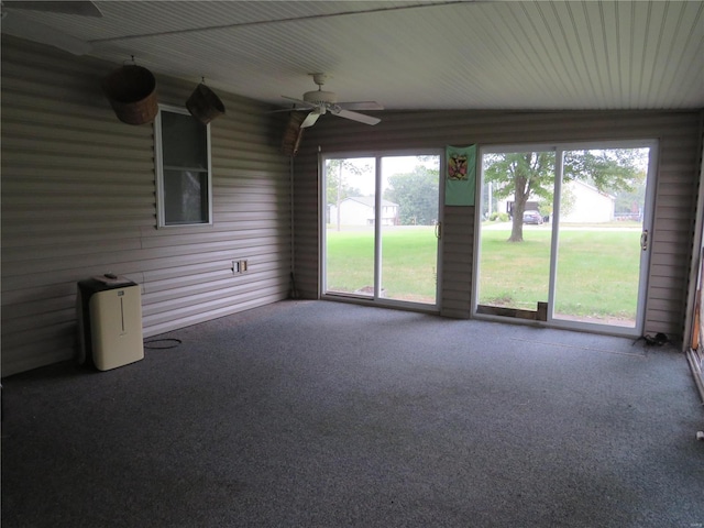 unfurnished sunroom featuring ceiling fan