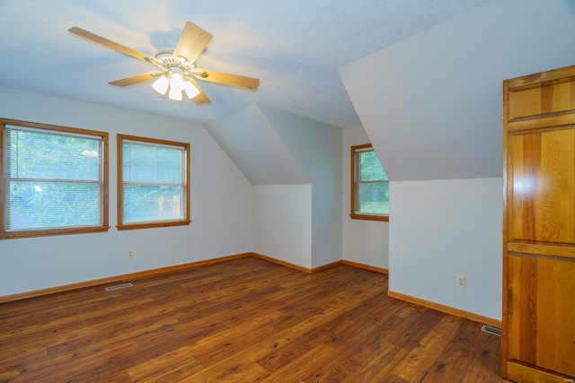 bonus room with visible vents, vaulted ceiling, baseboards, and hardwood / wood-style flooring