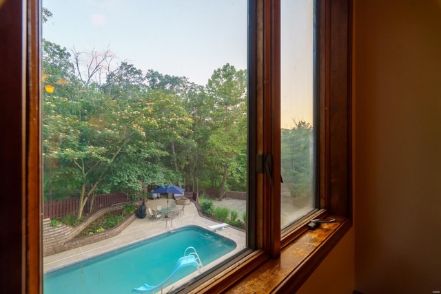 view of swimming pool featuring a hot tub and a diving board