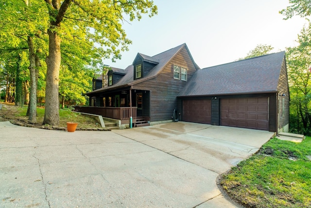 exterior space with a garage, driveway, and a porch