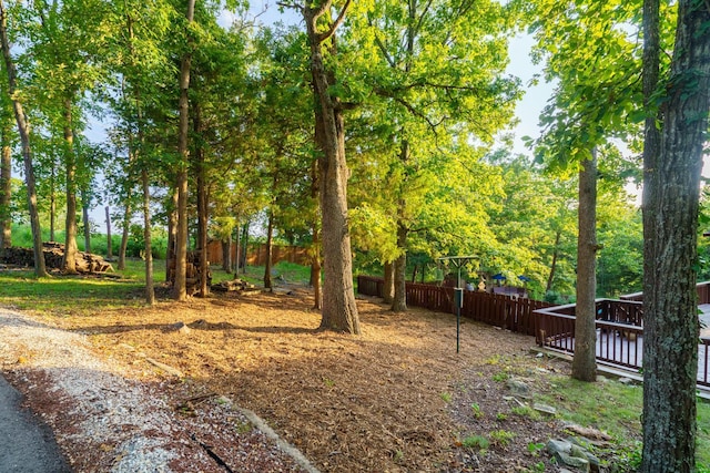 view of yard featuring fence and a deck