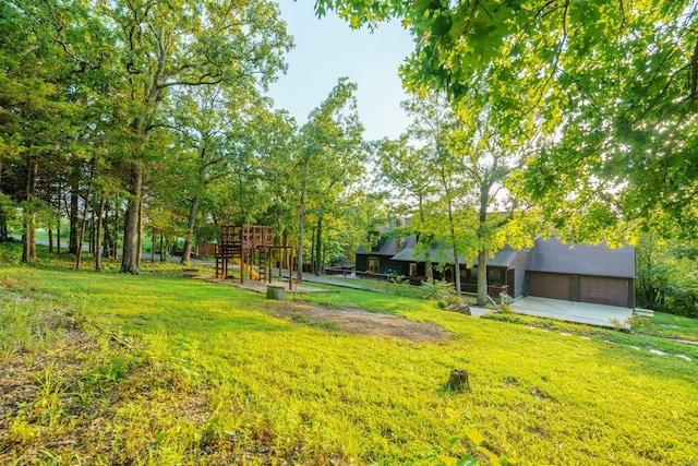 view of yard with a playground and an attached garage