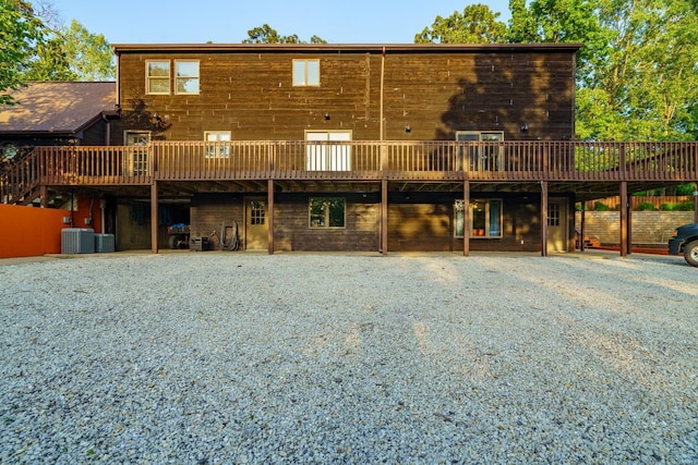 rear view of house featuring cooling unit and a deck