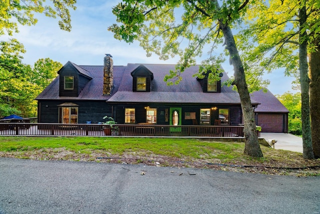 view of front of property featuring covered porch, a chimney, and a front lawn