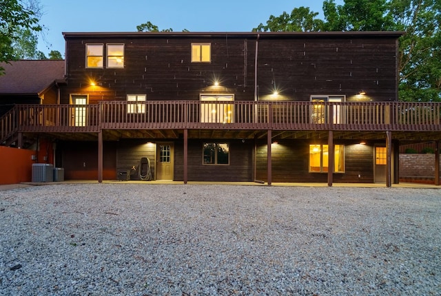 rear view of property with central AC and a wooden deck