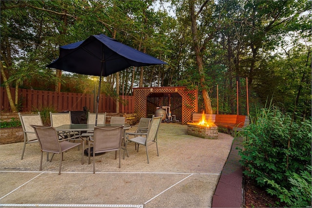 view of patio / terrace featuring an outdoor fire pit, fence, and outdoor dining area