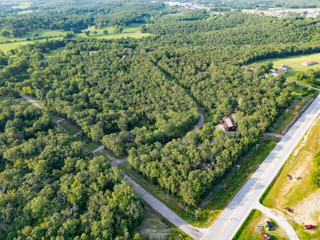 drone / aerial view featuring a forest view