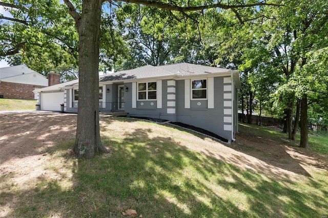 ranch-style house with a garage, a front yard, and covered porch