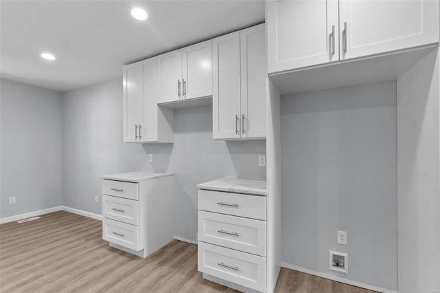 interior space with recessed lighting, visible vents, baseboards, light wood-style floors, and white cabinets