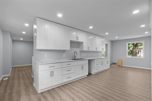 kitchen featuring sink, white cabinets, and light hardwood / wood-style floors