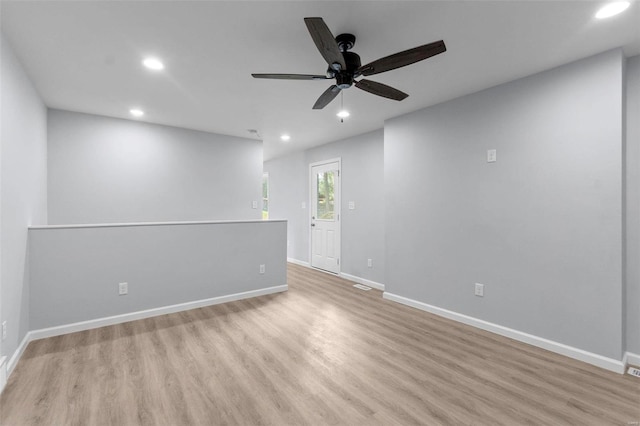 spare room featuring recessed lighting, ceiling fan, baseboards, and wood finished floors