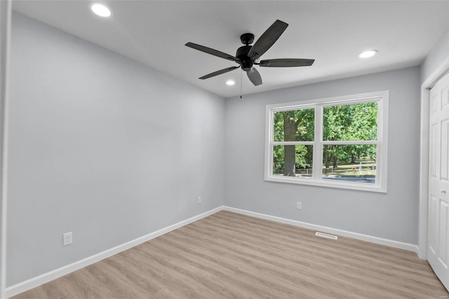 empty room with light hardwood / wood-style flooring and ceiling fan