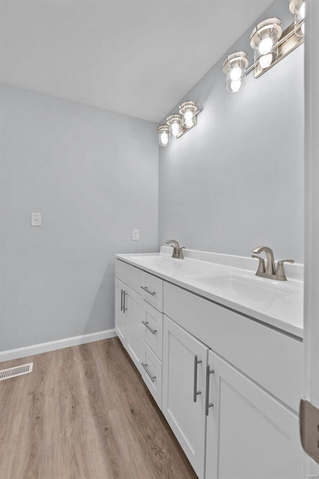 bathroom with vanity and hardwood / wood-style floors