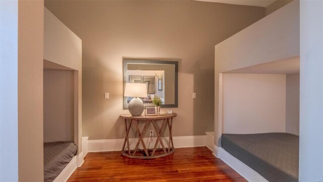 hallway featuring vaulted ceiling and hardwood / wood-style floors