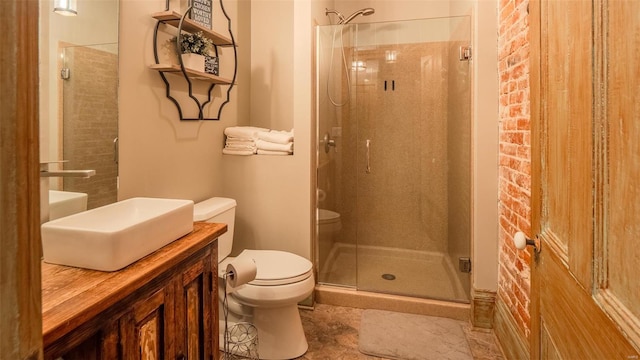 bathroom with a shower with door, vanity, tile patterned flooring, and toilet