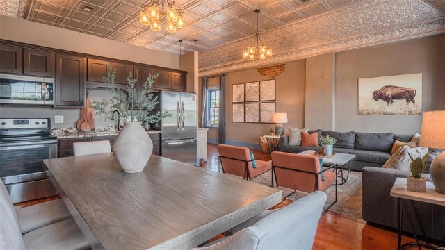 dining room featuring dark hardwood / wood-style floors, sink, and a chandelier