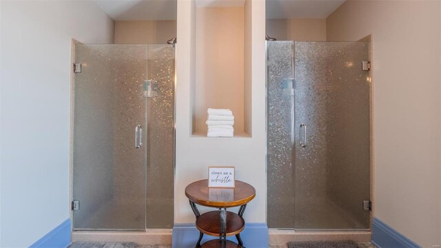 bathroom featuring a shower with door