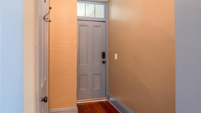 doorway with dark hardwood / wood-style floors