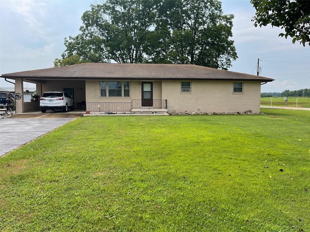 ranch-style home featuring a front lawn and a carport