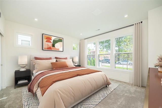 carpeted bedroom with multiple windows