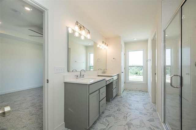 bathroom featuring vanity, a shower with door, and ceiling fan