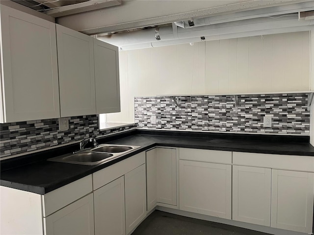 kitchen with sink, backsplash, and white cabinets