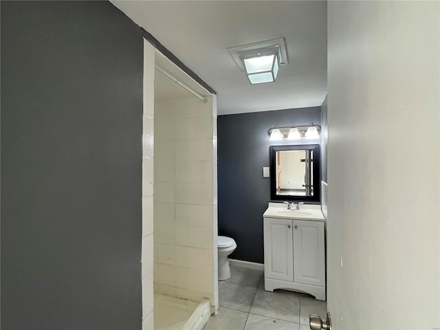 bathroom with a shower, toilet, vanity, and tile patterned flooring