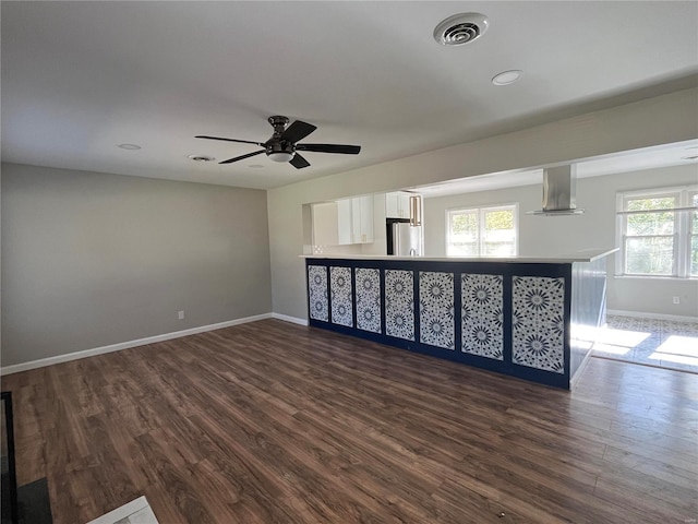 empty room with ceiling fan and dark wood-type flooring