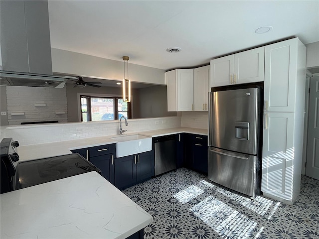 kitchen featuring sink, decorative backsplash, hanging light fixtures, and appliances with stainless steel finishes