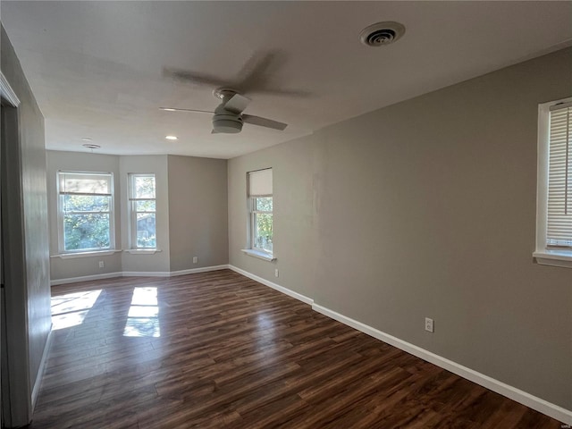 empty room with ceiling fan and dark wood-type flooring