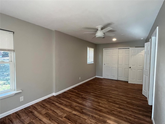 unfurnished bedroom featuring a closet, ceiling fan, and dark hardwood / wood-style floors