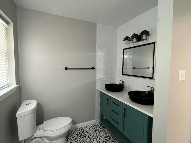 bathroom with decorative backsplash, tile patterned flooring, toilet, and a healthy amount of sunlight