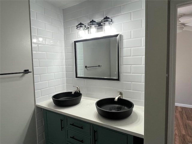 bathroom with vanity, tasteful backsplash, and wood-type flooring