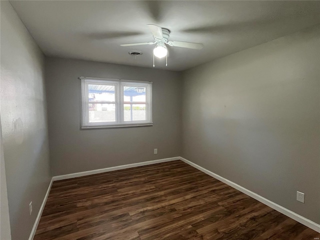 unfurnished room with ceiling fan and dark hardwood / wood-style flooring