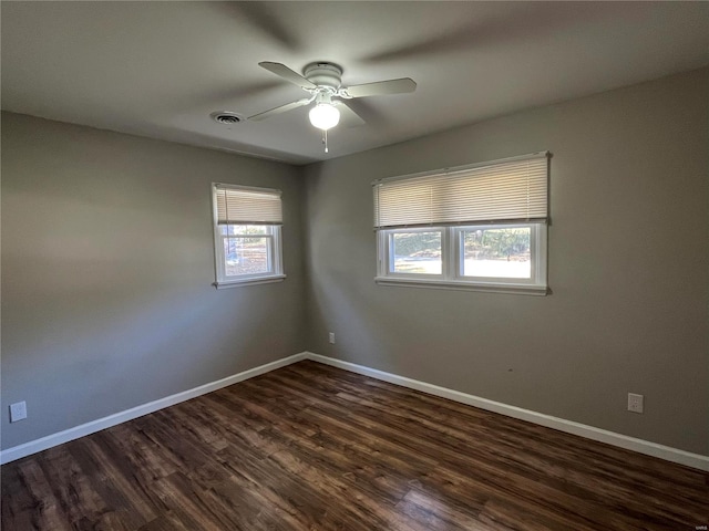 spare room with ceiling fan and dark hardwood / wood-style flooring