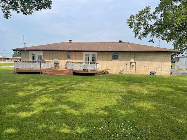 back of house with a deck and a yard