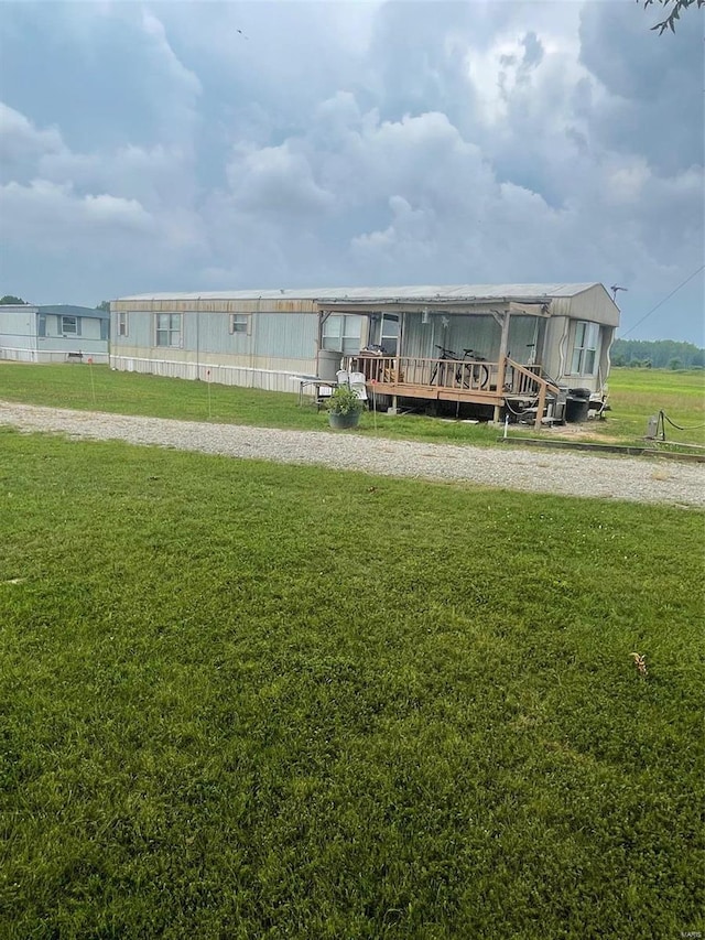 view of community with a wooden deck and a yard