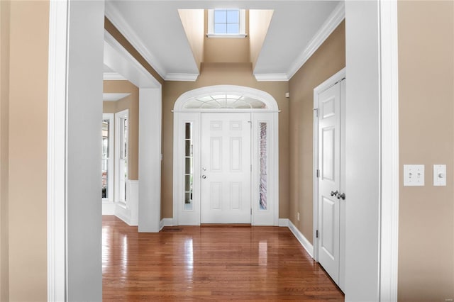 entryway featuring hardwood / wood-style floors, ornamental molding, and a healthy amount of sunlight