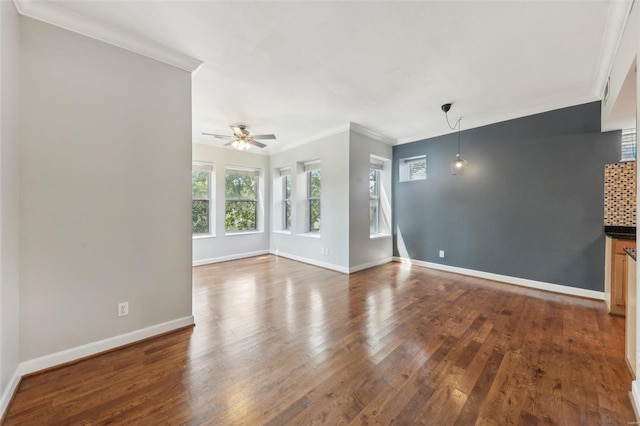 unfurnished living room featuring ornamental molding, dark wood finished floors, a ceiling fan, and baseboards