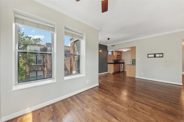 unfurnished room featuring crown molding, visible vents, dark wood finished floors, and baseboards