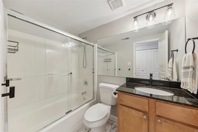 bathroom featuring enclosed tub / shower combo, visible vents, vanity, and toilet